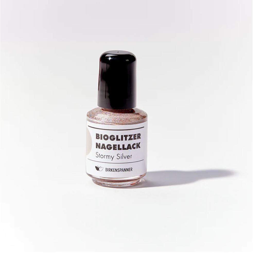 Silberner Bio-Glitzer Nagellack von Birkenspanner, auf einem Nagel aufgetragen, glänzend und schimmernd für ein trendiges Nageldesign
